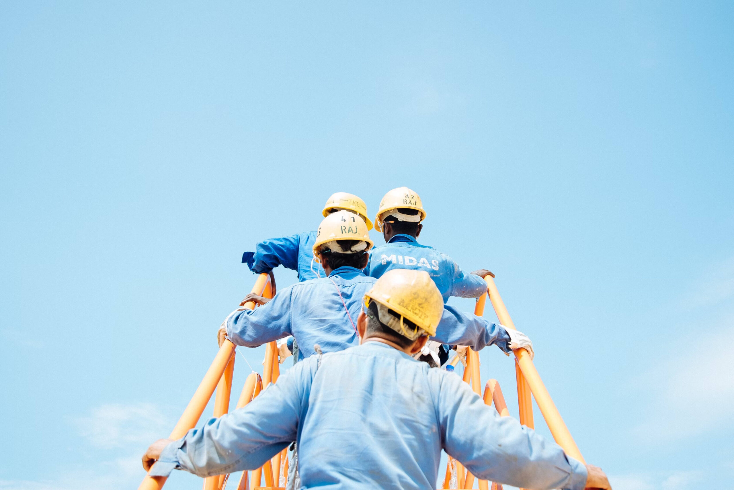 Work Opportunity Tax Credit – workers climbing scaffolding, symbolizing RDIG’s service that removes complexity from claiming new hire tax incentives