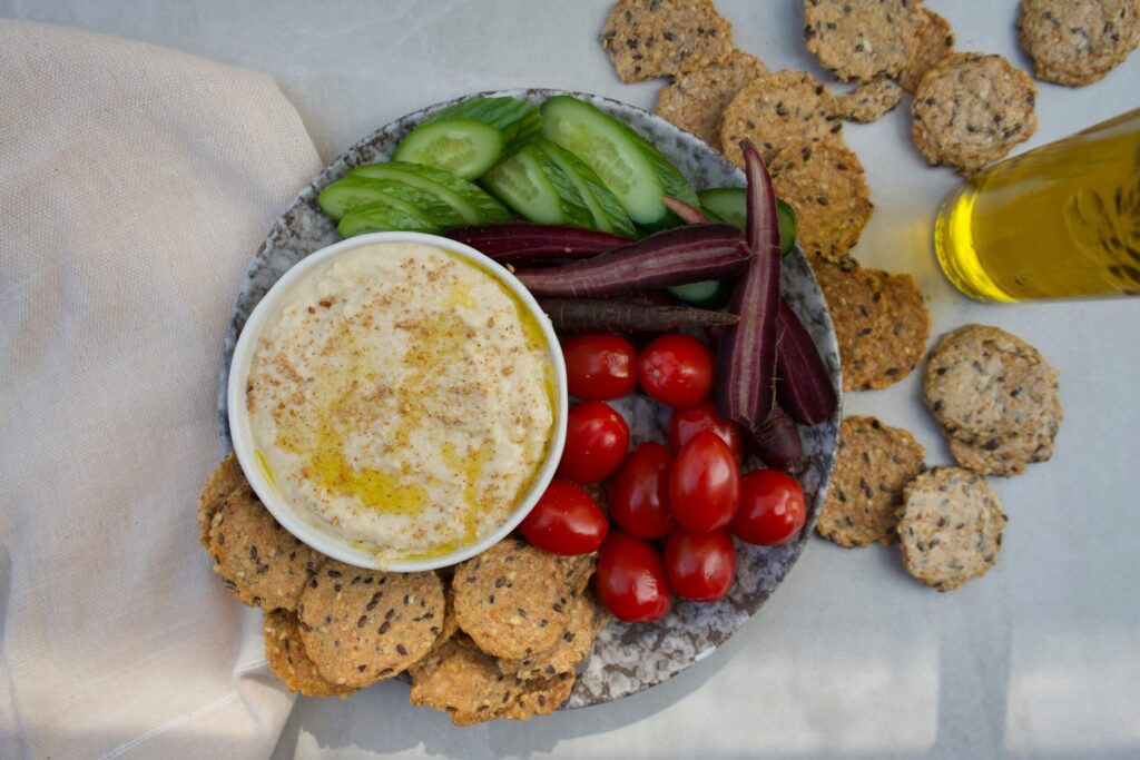 vegetables and crackers on a plate on a tablecloth