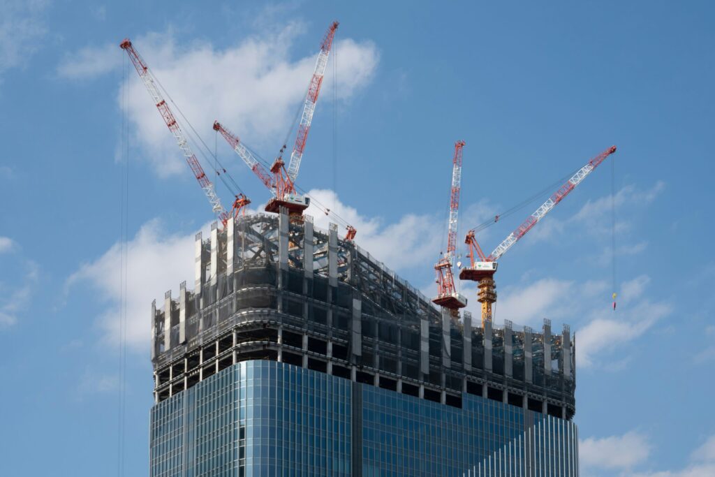 top of a building being constructed by cranes